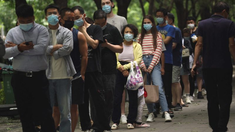 Люди стоят в очереди на анализы нуклеиновых кислот у передвижного стенда для тестирования после вспышки COVID-19 в Пекине, Китай, 13 июня 2022 года. (TingshuWang/Reuters) | Epoch Times Media